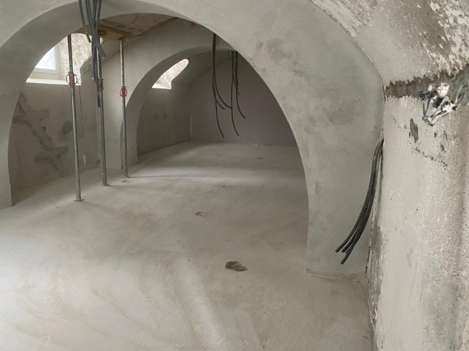 Cave voutée entièrement vidée avec voutes en plâtre blanc visibles après débarras